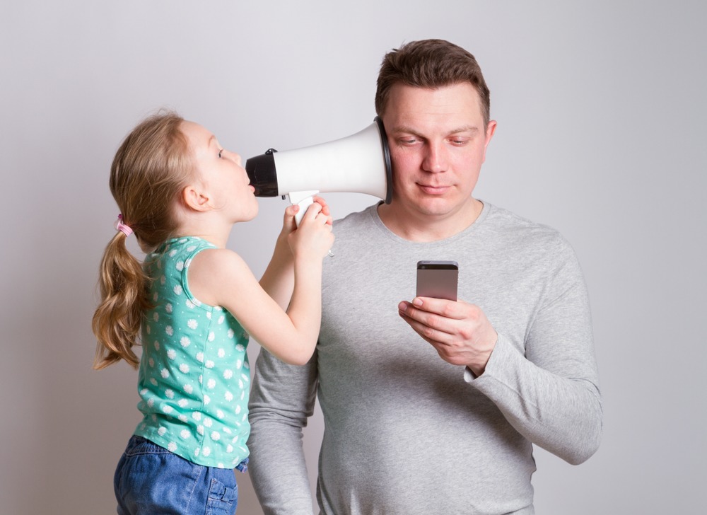 Father using phone for teaching patience